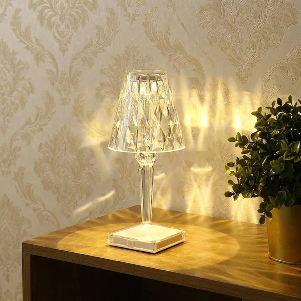 Kira Crystal Lamp – clear finish lit on a wooden desk