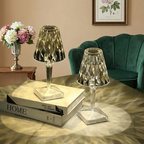 Kira Crystal Lamp – two amber lamps lit on stacked books