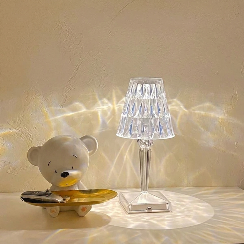 Kira Crystal Lamp – clear finish lit beside a toy bear