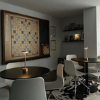 Halden Cordless Table Lamp – lit on round tables in a café