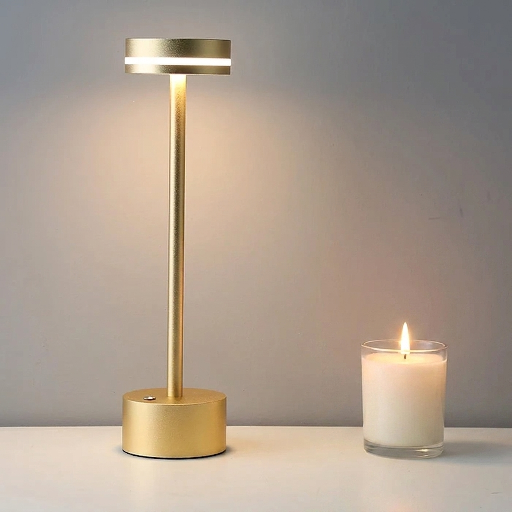 Halden Cordless Table Lamp – lit beside a candle on a shelf