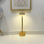 Halden Cordless Table Lamp – lit on a countertop below a framed print