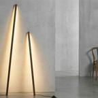 Linden Wooden LED Floor Lamp – two lamps leaning against a concrete wall