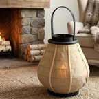 Hollis Wooden Candle Lantern – lit lantern beside a stone fireplace