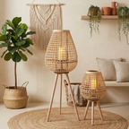 Cove Rattan Candle Lantern – pair on tripod legs beside a sofa
