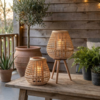Cove Rattan Candle Lantern – pair on a patio table at dusk