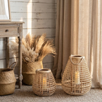 Cove Rattan Candle Lantern – two lanterns beside a basket and dried grasses