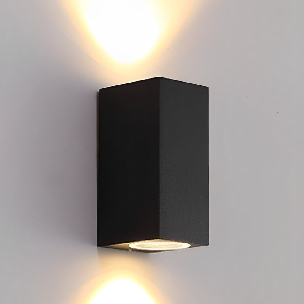 Square Outdoor Up & Down Wall Light – lit up and down on a plain wall