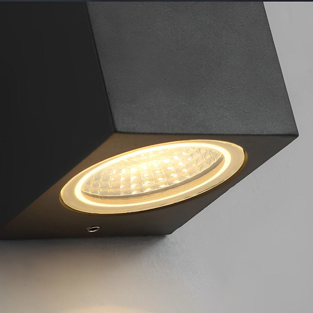 Square Outdoor Up & Down Wall Light – close-up of the lit lens, white background